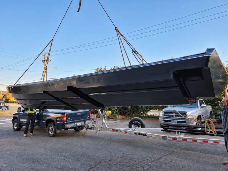 Finished marine composite hull component on transport